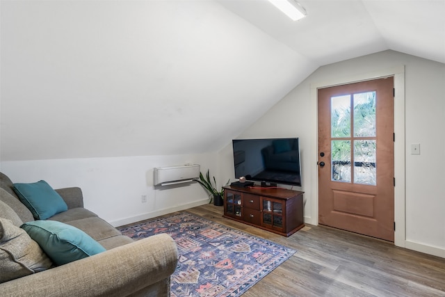 living area featuring baseboards, lofted ceiling, and wood finished floors