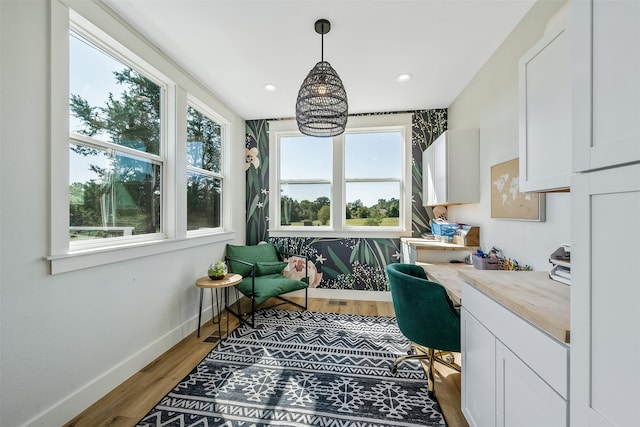 office space with recessed lighting, wood finished floors, built in desk, and baseboards