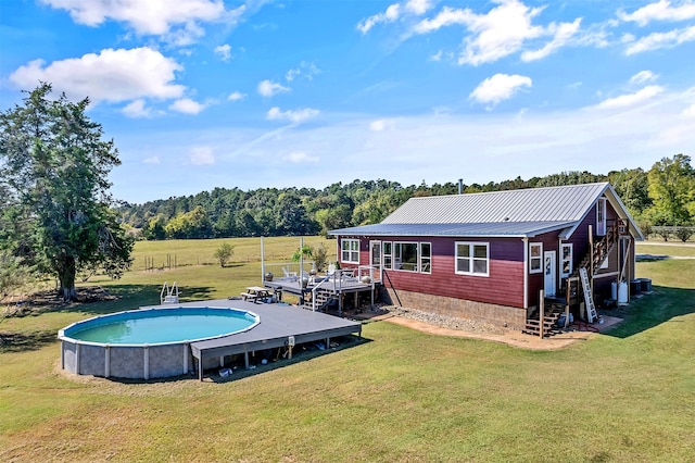 view of pool featuring a rural view and a lawn