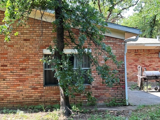 view of side of property with a patio