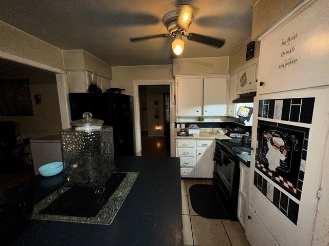 kitchen featuring a textured ceiling, ceiling fan, black appliances, light tile patterned floors, and white cabinets