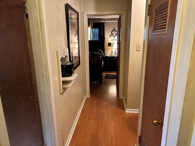 hallway with wood-type flooring