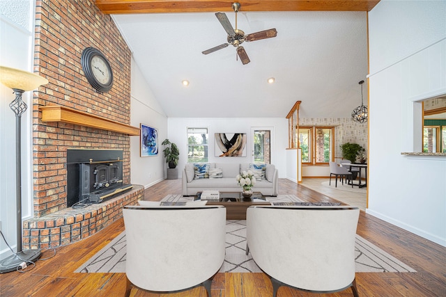 living room featuring high vaulted ceiling, beamed ceiling, ceiling fan, and light hardwood / wood-style floors