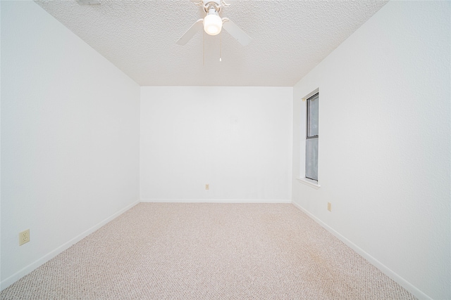 spare room featuring carpet floors, a textured ceiling, and ceiling fan