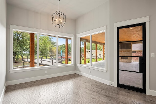 unfurnished sunroom with a chandelier and plenty of natural light