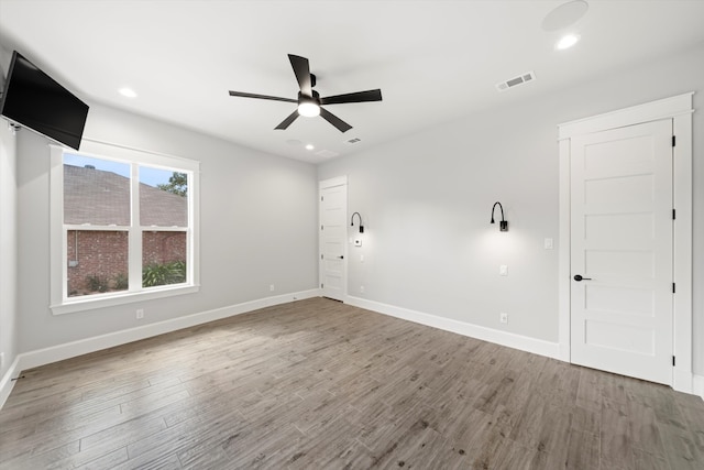 spare room with ceiling fan and hardwood / wood-style flooring