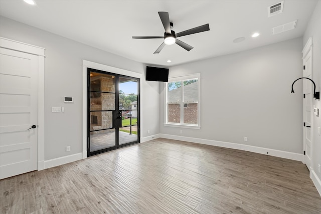 empty room with wood-type flooring and ceiling fan