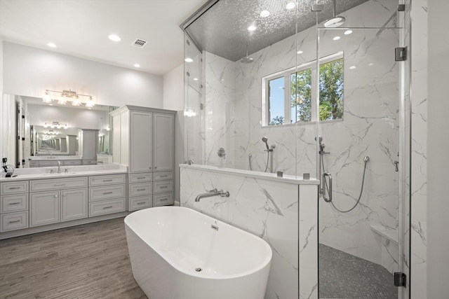 bathroom with vanity, plus walk in shower, wood-type flooring, and tile walls