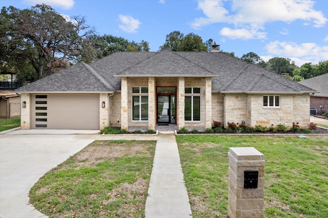 view of front of property with a front lawn and a garage