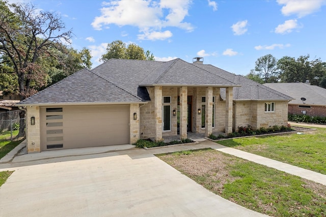 view of front of house featuring a front yard and a garage