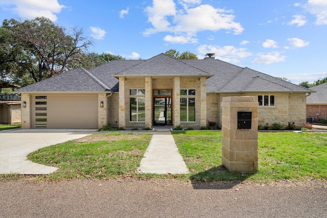 view of front of property with a garage and a front lawn