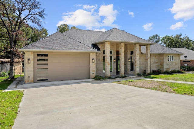 view of front facade featuring a garage and a front lawn