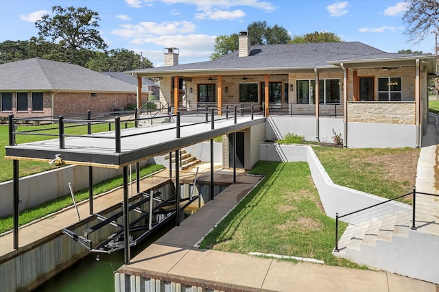 rear view of property featuring a patio and a lawn