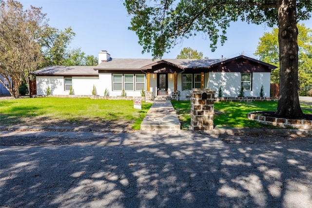 ranch-style home with a front lawn