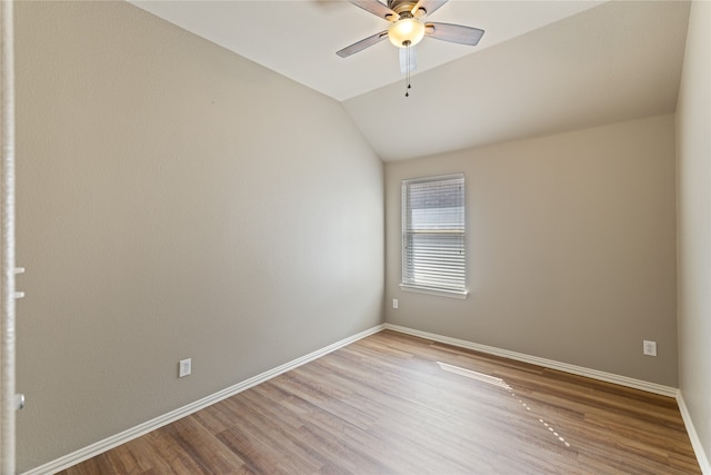 empty room featuring lofted ceiling, ceiling fan, and light hardwood / wood-style flooring