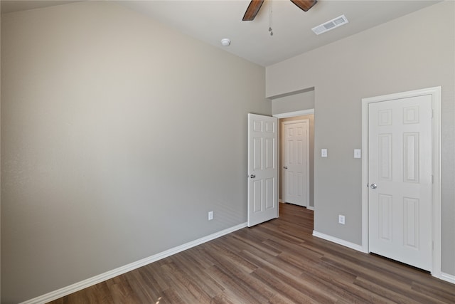 unfurnished bedroom featuring dark hardwood / wood-style flooring and ceiling fan