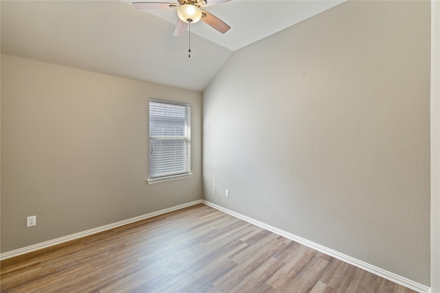 unfurnished room featuring lofted ceiling, light hardwood / wood-style floors, and ceiling fan