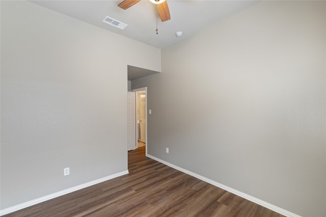 empty room with ceiling fan and dark wood-type flooring