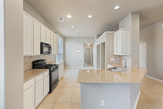 kitchen with black appliances, light stone countertops, white cabinets, sink, and kitchen peninsula