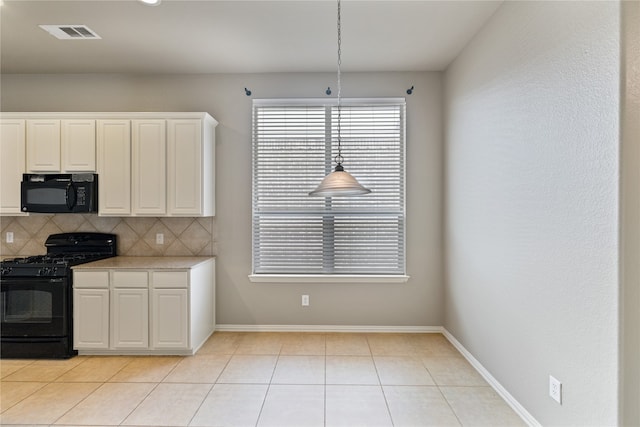 kitchen featuring hanging light fixtures, black appliances, decorative backsplash, and white cabinetry