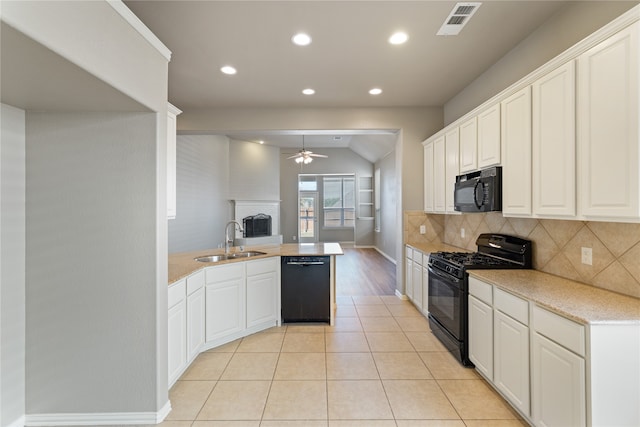 kitchen featuring kitchen peninsula, black appliances, sink, and white cabinets