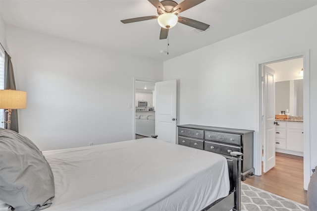 bedroom with connected bathroom, light hardwood / wood-style flooring, and ceiling fan