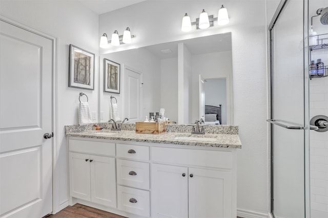 bathroom featuring vanity, wood-type flooring, and walk in shower