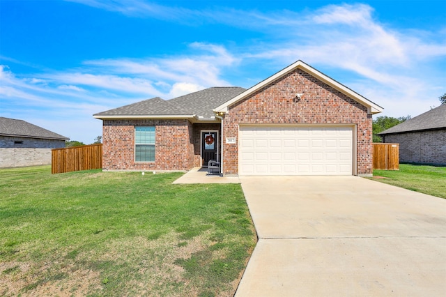 view of front of property with a front yard and a garage