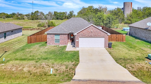 view of front of property with a garage and a front lawn