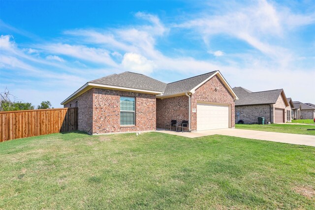 single story home featuring a garage and a front lawn