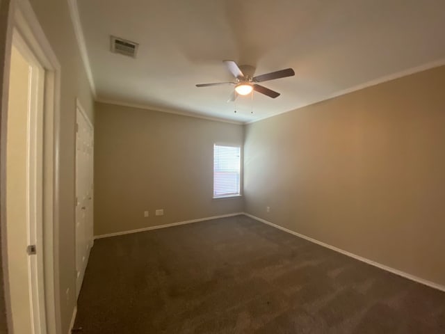 carpeted empty room featuring ornamental molding and ceiling fan