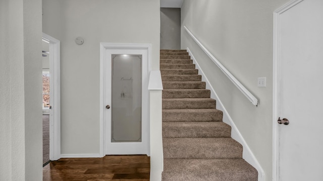 staircase featuring wood finished floors