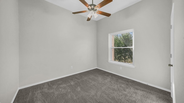 unfurnished room with baseboards, dark colored carpet, and ceiling fan