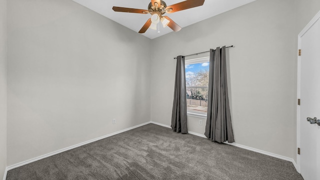 carpeted spare room featuring baseboards and ceiling fan