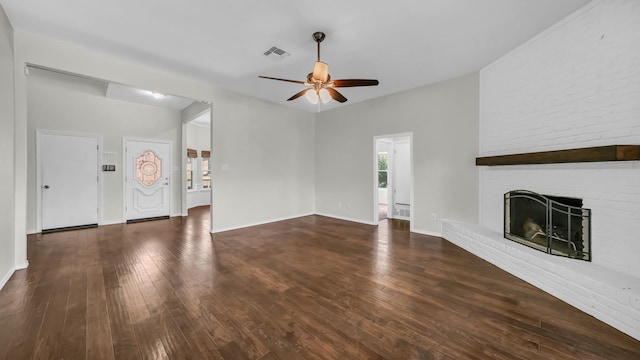 unfurnished living room featuring a ceiling fan, visible vents, baseboards, wood-type flooring, and a brick fireplace