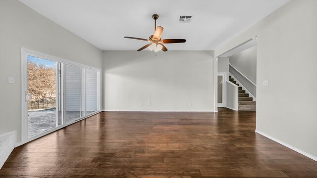 unfurnished living room with visible vents, stairs, a ceiling fan, and wood finished floors