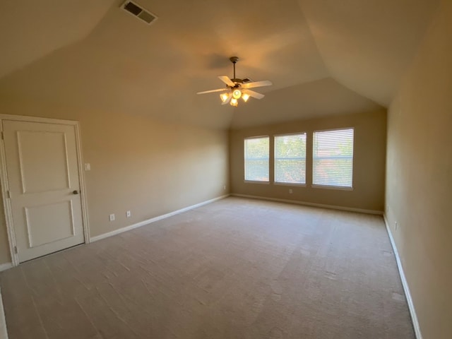 unfurnished room featuring lofted ceiling, ceiling fan, and light carpet