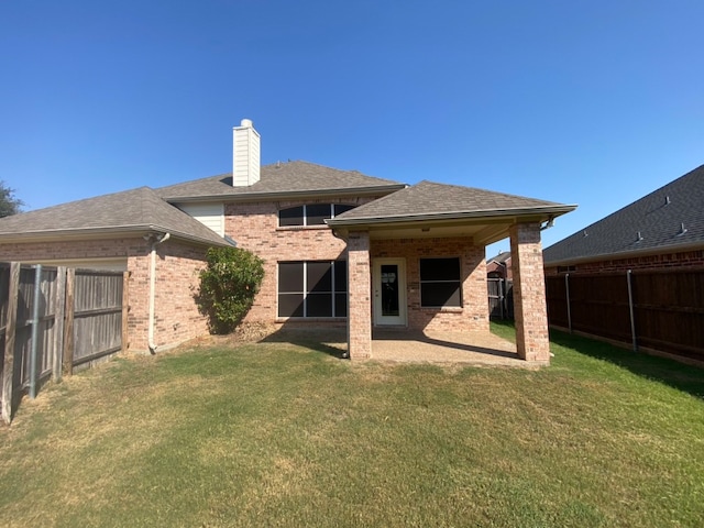 rear view of property featuring a yard