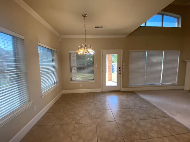 unfurnished dining area with light tile patterned flooring, crown molding, and an inviting chandelier