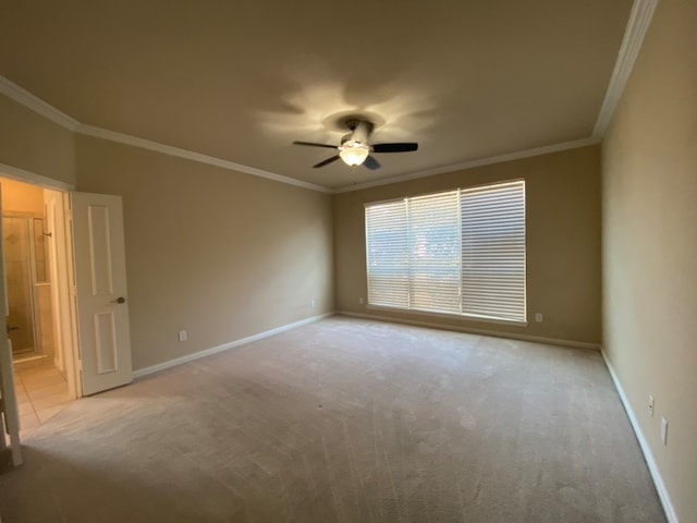 spare room with light carpet, ornamental molding, and ceiling fan