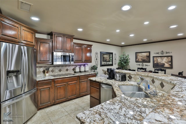 kitchen with stainless steel appliances, light stone countertops, light tile patterned flooring, and sink