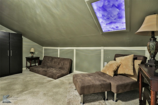 living area with carpet floors, vaulted ceiling, and a textured ceiling