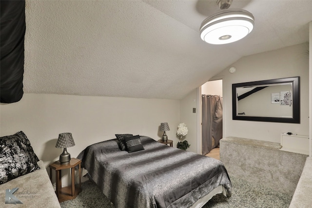 bedroom featuring a textured ceiling, lofted ceiling, and carpet flooring