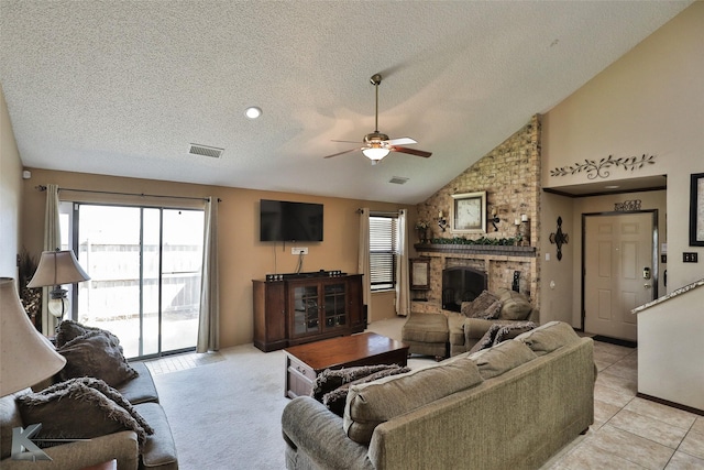 3153 Curry Ln Unit D3, Abilene, TX 79605 - living area featuring ceiling fan, a textured ceiling, a fireplace, vaulted ceiling, and light tile patterned floors