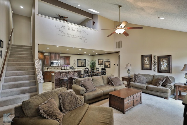 3153 Curry Ln Unit D3, Abilene, TX 79605 - living room with ceiling fan, stairs, high vaulted ceiling, and light colored carpet