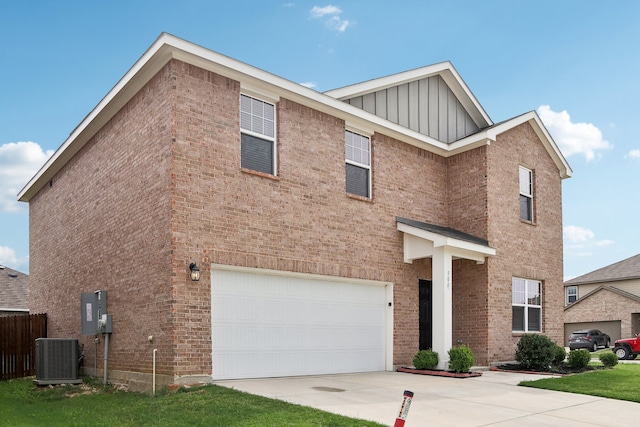 view of front of property featuring a front yard, a garage, and central air condition unit