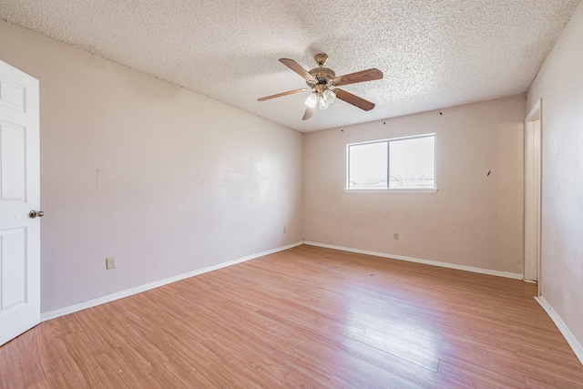 spare room with a textured ceiling, ceiling fan, and light hardwood / wood-style floors