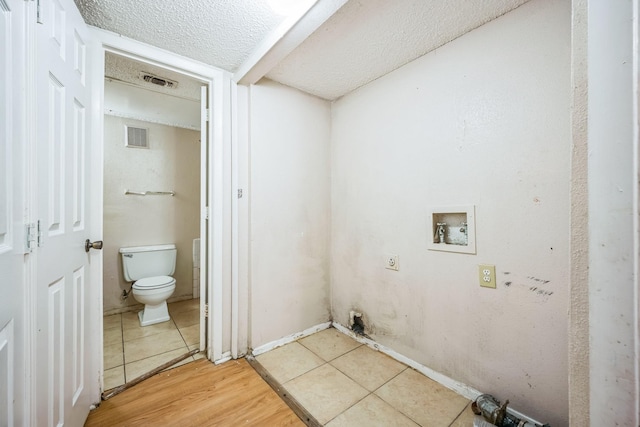 laundry room featuring tile patterned flooring and washer hookup