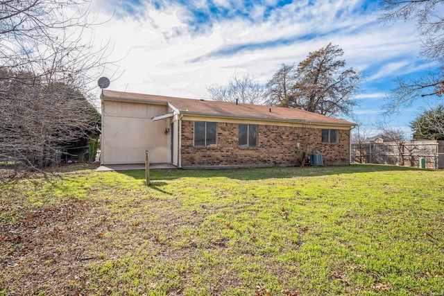 back of house featuring central AC and a lawn