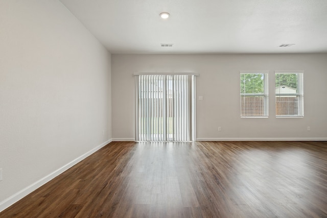 empty room with dark hardwood / wood-style floors